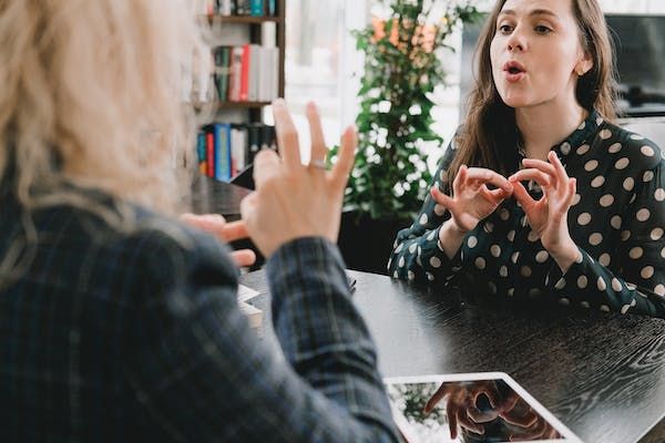 Two lady learning with sign language