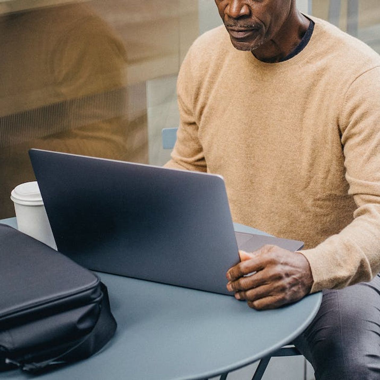 A man making new lessons for his online students using captions